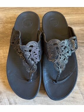 FitFlop Flora thong sandals featuring a laser-cut, intricate design on the strap
